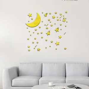 Close-up of yellow acrylic moon and star mirror wall stickers on a clean white wall