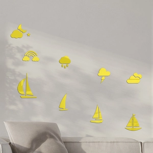 Macro detail of glossy yellow acrylic mirror wall stickers with boat and cloud shapes