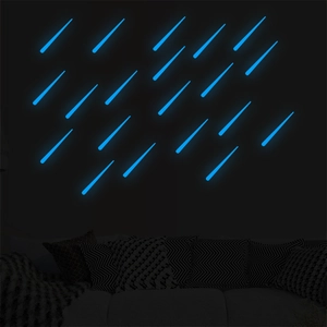 Luminous blue meteor wall stickers showing vibrant glow in a dark bedroom setting