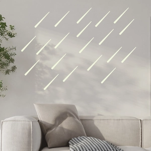 Close-up of luminous meteor wall stickers applied in a modern minimalist bedroom decor