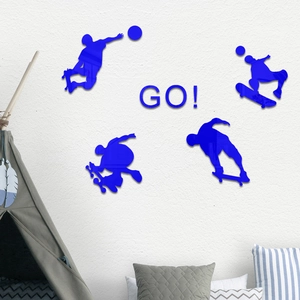 Detail view of blue acrylic skateboarder silhouettes and GO! sign on a white wall