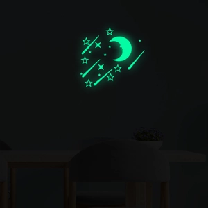Luminous wall stickers set featuring moon and stars glowing bright green in the dark