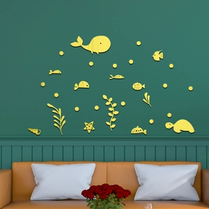 Yellow acrylic ocean wall stickers with whales and turtles on a dark green wall decor