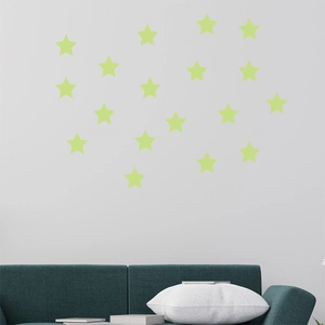 Detailed close-up of luminous green star wall stickers in a modern home interior setting
