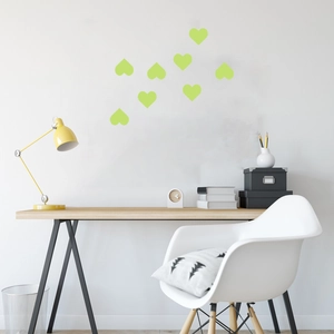 Luminous green heart wall stickers for kids' bedrooms shown in a modern home office setting