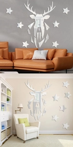 Macro detail of geometric stag head mirror wall sticker with star accents in living room