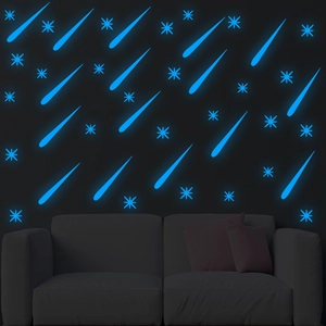 Luminous wall stickers featuring blue glowing meteors and stars for dark room decor
