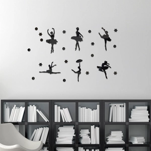 Detailed view of 6 black acrylic ballet dancer silhouettes on a white living room wall