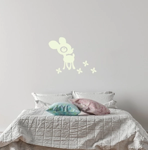 Luminous cute deer and floral wall stickers glowing in a cozy child's bedroom setting