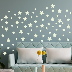 Luminous star wall stickers set for children's bedroom decor on a blue wall background