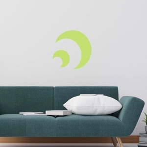 Luminous crescent moon wall decal glowing in soft green on a modern bedroom wall