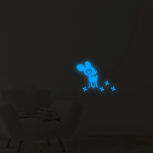 Close-up of blue glowing cartoon deer and stars wall stickers in a dark nursery