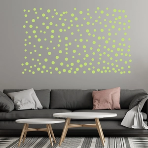 Glow in the dark circular wall stickers in various sizes on a modern grey interior wall