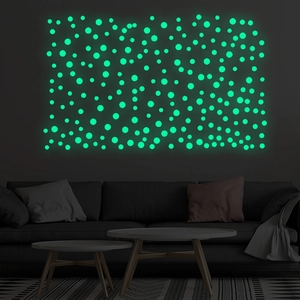 Luminous green dot wall stickers glowing in a dark modern living room setting