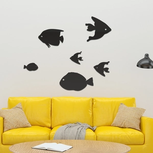 Set of six black acrylic fish-shaped wall stickers displayed above a modern yellow sofa
