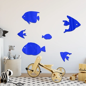 Blue acrylic ocean fish wall stickers decorating a cozy children's nursery room wall