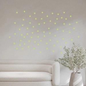 Detailed view of luminous green star wall stickers in a modern minimalist living room