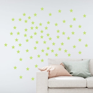 Luminous glow-in-the-dark star wall stickers for kids bedroom decor over a beige sofa