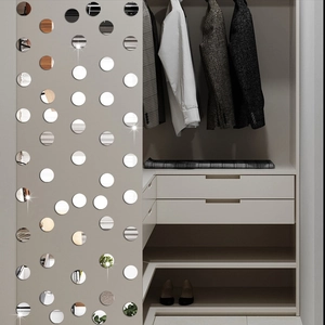 Detail of round mirror wall stickers with reflective surface on a modern closet side
