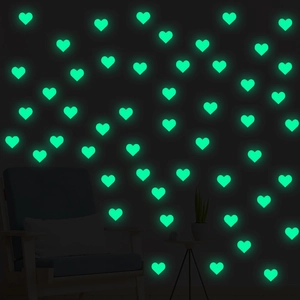 Green glow in the dark heart wall stickers for bedroom decor set against dark wall