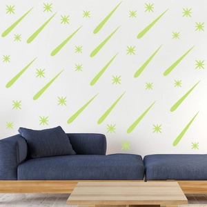Detailed view of light green luminous meteor and star wall stickers on a white wall