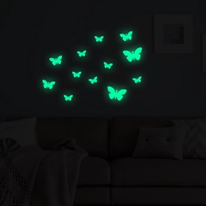 Luminous green glow butterfly wall stickers DIY set on wall above a sofa in the dark