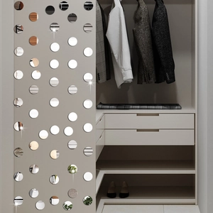 Macro detail of circular mirror wall stickers showing high reflective finish on wardrobe