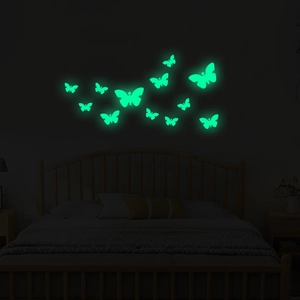 Luminous butterfly wall stickers set showing glowing green fluorescence in dark bedroom