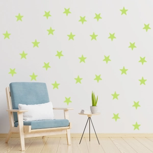 Luminous star wall stickers glowing in a cozy bedroom with minimalist furniture decor