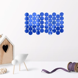 Deep blue acrylic mirror wall decals arranged in a matrix on a white living room wall