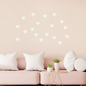 DIY glowing heart wall stickers arranged in a cozy living room scene with soft pink tones