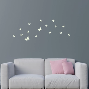 Detailed view of luminous butterfly wall stickers glowing in a dark modern living room