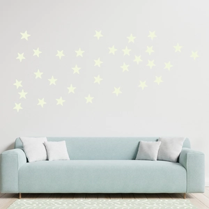 Modern living room wall decorated with various sized glowing star stickers on a white wall