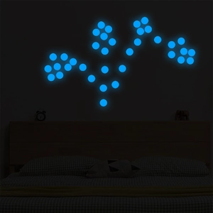 Luminous blue round dot wall decals glowing in dark bedroom background scene