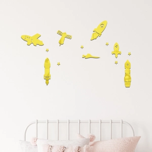 Close-up of yellow mirror rocket and star wall stickers in a child's bedroom setting