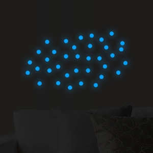 Luminous geometric dot wall stickers with blue glow effect in dark bedroom or living room