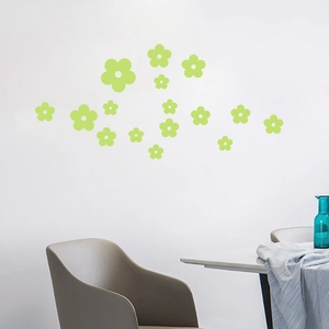 Detailed view of light green floral luminous wall decals on a minimalist white living room wall