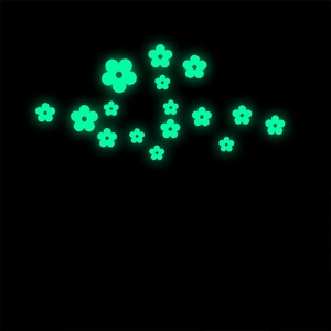 Detail of glow in the dark floral wall stickers in neon green light on black background