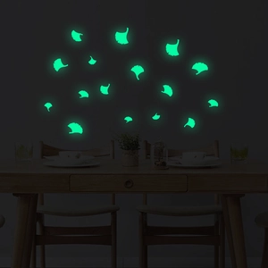 Luminous ginkgo leaf wall stickers glowing in a dark dining room interior setting