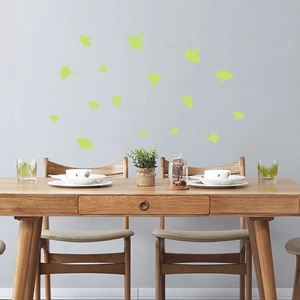 Ginkgo leaf glow-in-the-dark wall stickers for living room decor on a grey wall surface