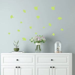 Luminous ginkgo leaf wall stickers set in a cozy living room with glow in the dark effect