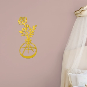 Close-up of golden acrylic mirror wall decal featuring a minimalist flower in a vase