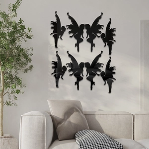 Detail view of 8 black 3D fairy acrylic wall stickers displayed above a gray fabric sofa