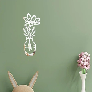 Detail of 3D acrylic mirror wall sticker showing floral vase design on green wall