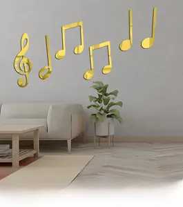 Close-up of golden mirror musical note wall decals on a modern minimalist grey wall