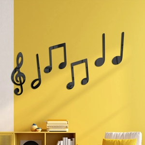 3D acrylic music notes on a yellow wall showing glossy mirror finish and 3D depth