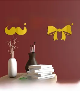 Close-up of golden acrylic 3D mirror wall stickers featuring Mr. & Mrs. wedding decor