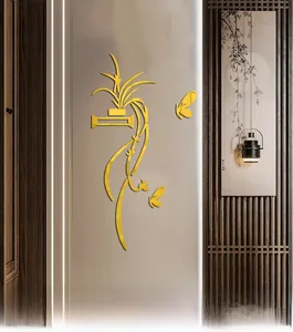 Detailed macro of golden 3D acrylic wall stickers with plant and butterfly motifs