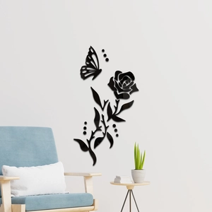 Detail view of 3D black acrylic rose and butterfly wall sticker on a white bedroom wall