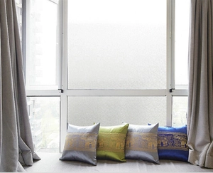 Set of 4 Thai-style decorative pillows with golden elephant patterns on a window sill